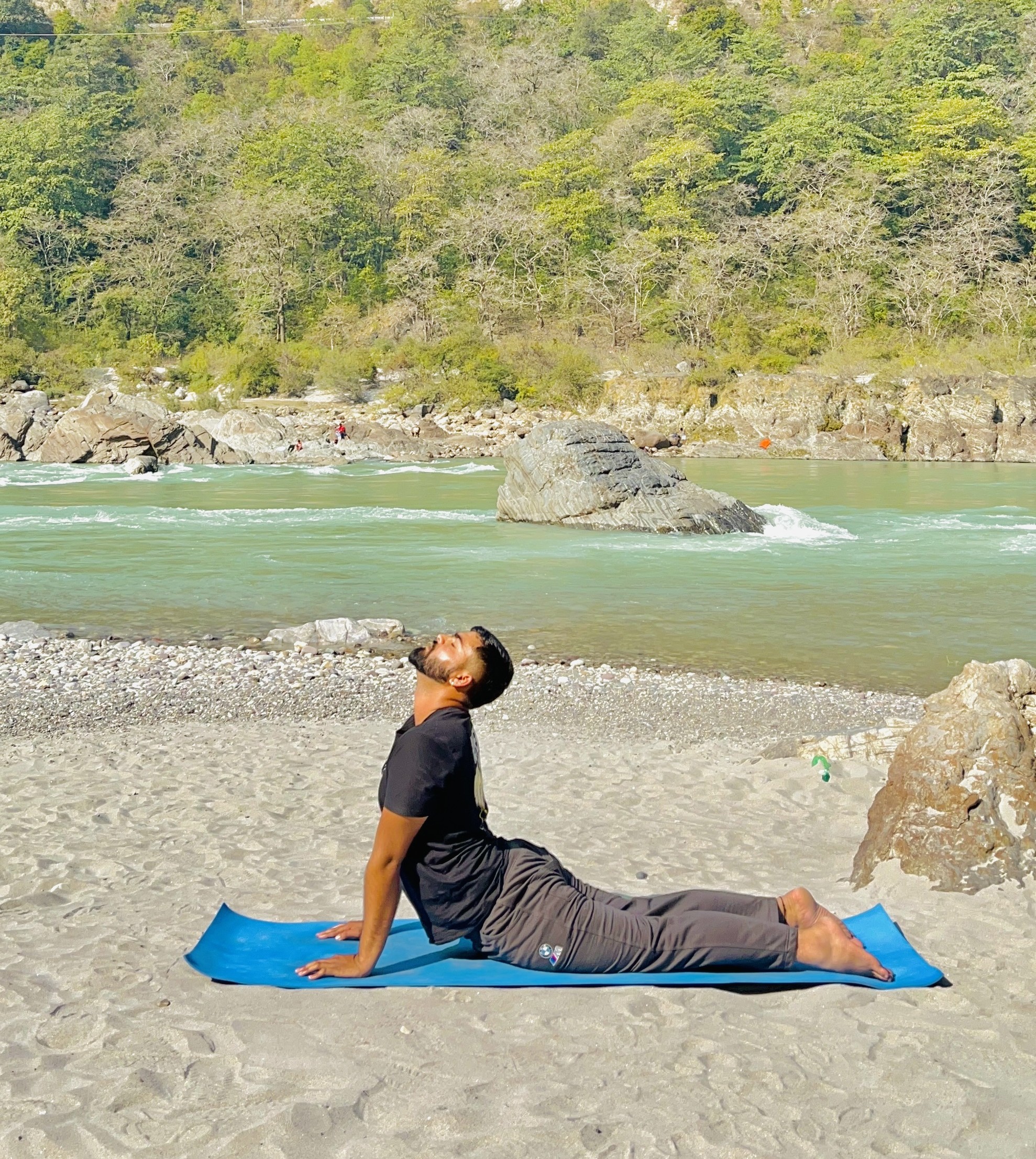 Yoga teacher Aniket Saini practicing by the river in Haridwar